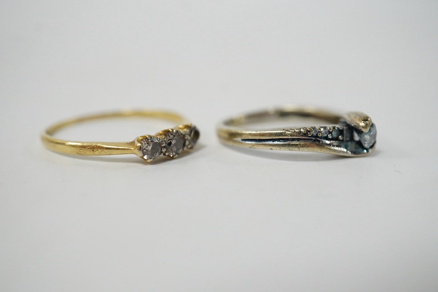 A small yellow metal and three stone diamond set ring, size R/S and a modern 9kt and single stone diamond ring, with diamond chip set shoulders, gross weight 4.3 grams.